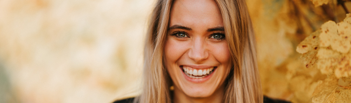 Katharina kann Fröhliche Frau genießt Wein im Weinkeller, lächelt.